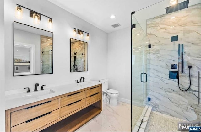 full bathroom featuring a sink, visible vents, marble finish floor, a marble finish shower, and double vanity