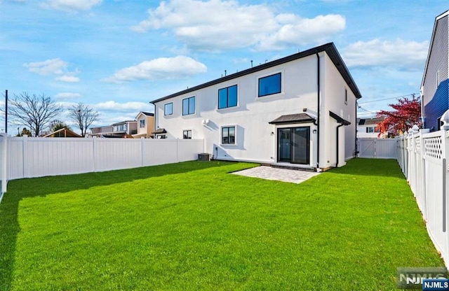 back of house with stucco siding, a fenced backyard, cooling unit, and a yard