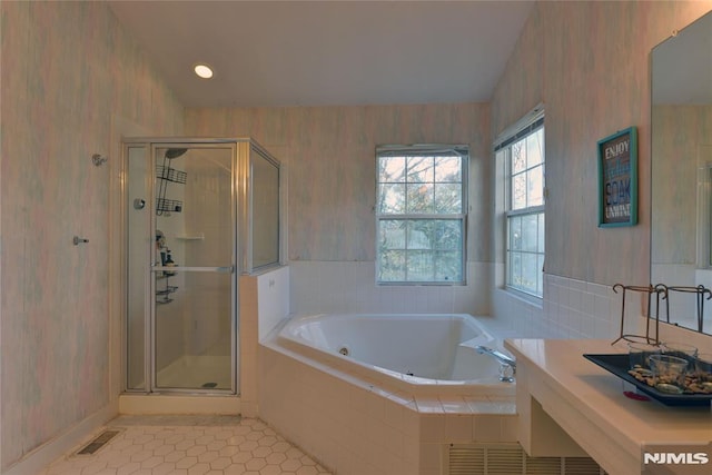 full bath featuring a garden tub, visible vents, wallpapered walls, a stall shower, and tile patterned floors