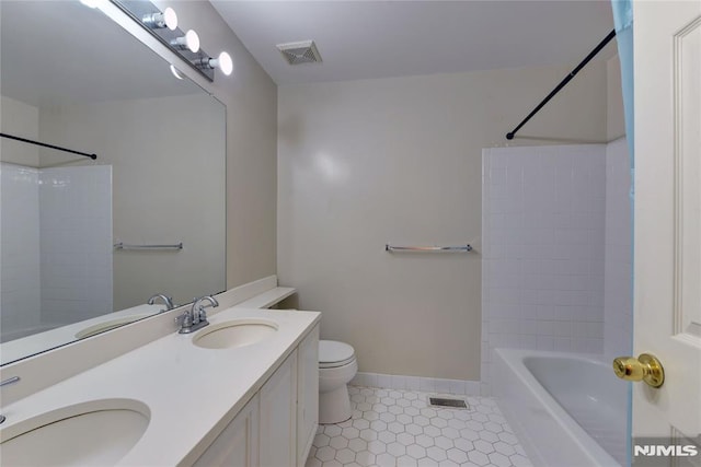 bathroom with toilet, visible vents, and a sink