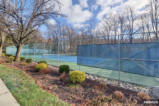 view of tennis court with fence