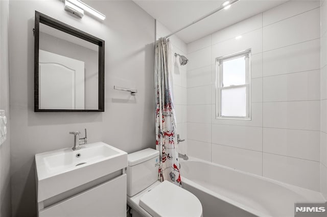 bathroom with vanity, toilet, and shower / tub combo with curtain