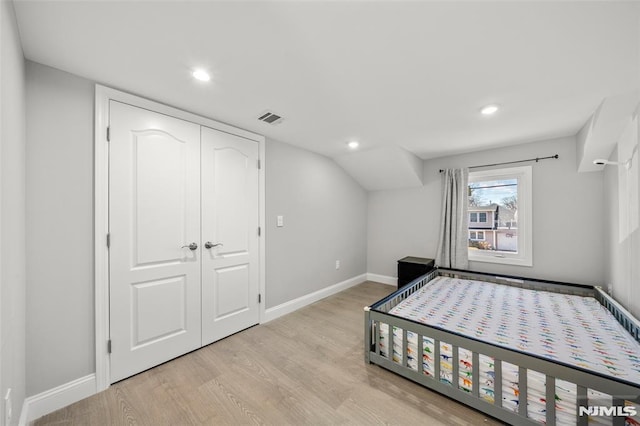 bedroom with recessed lighting, visible vents, light wood-style flooring, and baseboards