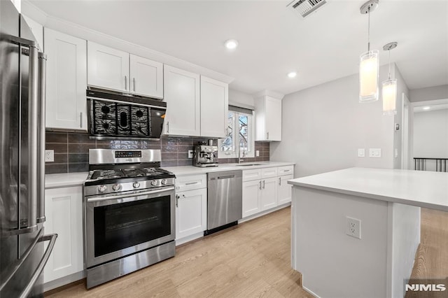 kitchen with visible vents, light wood-type flooring, light countertops, appliances with stainless steel finishes, and a sink