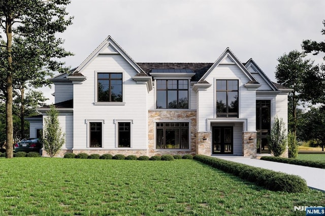 view of front of house featuring stone siding and a front lawn