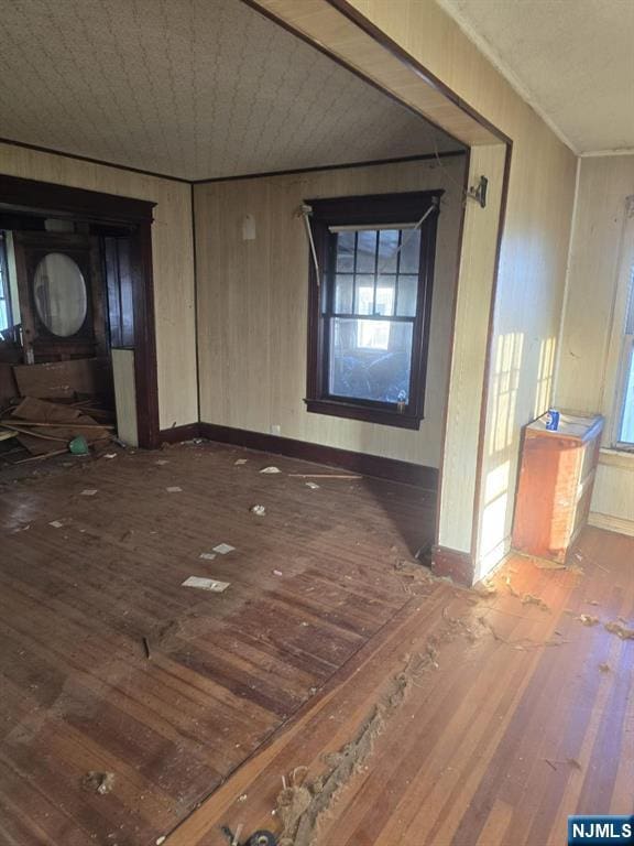 interior space with wood-type flooring and baseboards