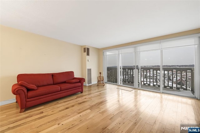 living room with baseboards and hardwood / wood-style floors