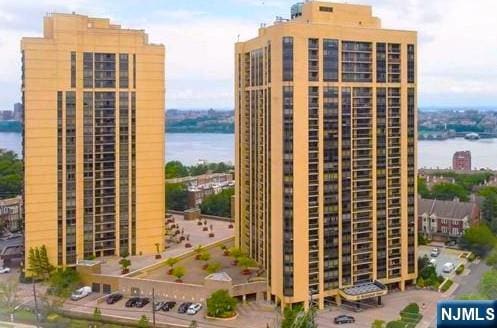 view of building exterior with a water view and a view of city