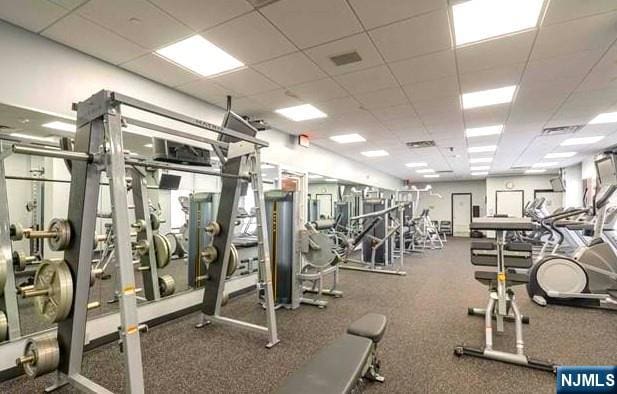 gym featuring a drop ceiling and visible vents