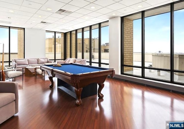 rec room with visible vents, floor to ceiling windows, billiards, and wood finished floors