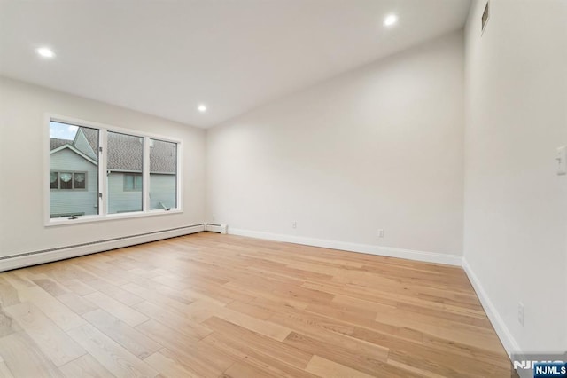 unfurnished room featuring visible vents, baseboards, light wood-type flooring, baseboard heating, and recessed lighting