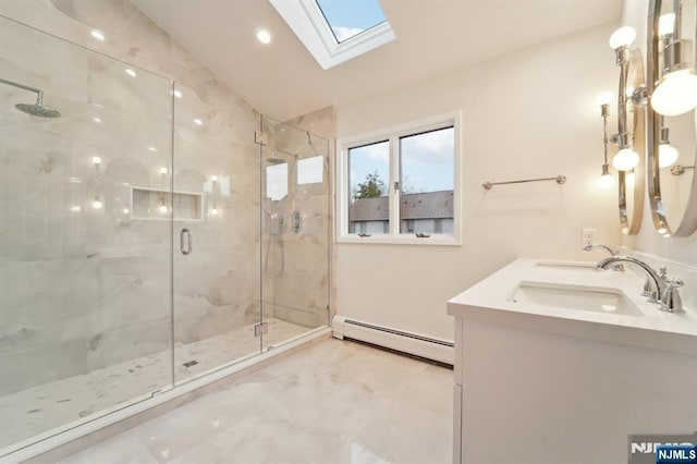 bathroom featuring lofted ceiling with skylight, a sink, a marble finish shower, double vanity, and baseboard heating