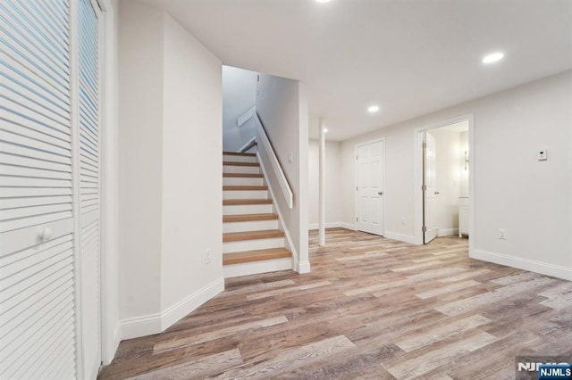 interior space featuring recessed lighting, wood finished floors, and baseboards