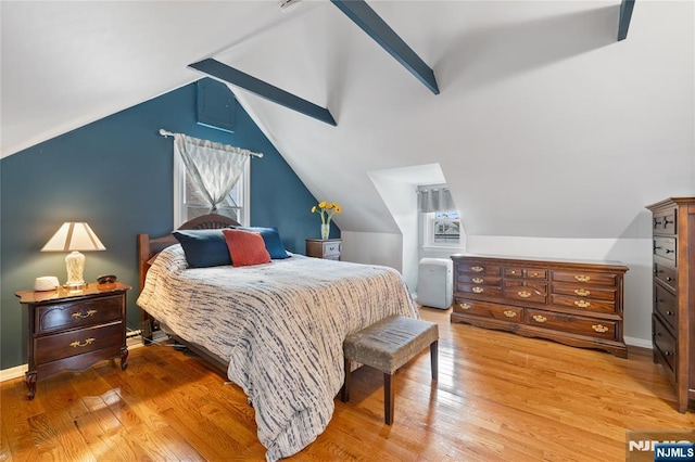 bedroom featuring light wood-style flooring, lofted ceiling with beams, and baseboards