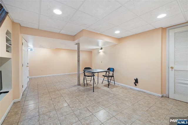 unfurnished dining area featuring a drop ceiling, recessed lighting, and baseboards