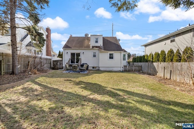 back of property featuring a patio, a lawn, and a fenced backyard