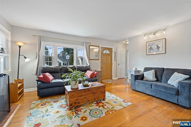 living area with light wood-style floors and baseboards