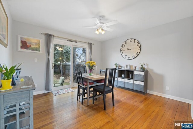 dining room with light wood-style flooring, a ceiling fan, and baseboards