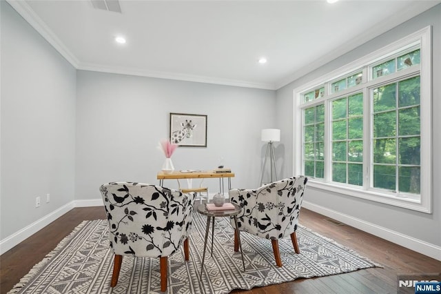 sitting room featuring visible vents, baseboards, dark wood-style flooring, and crown molding