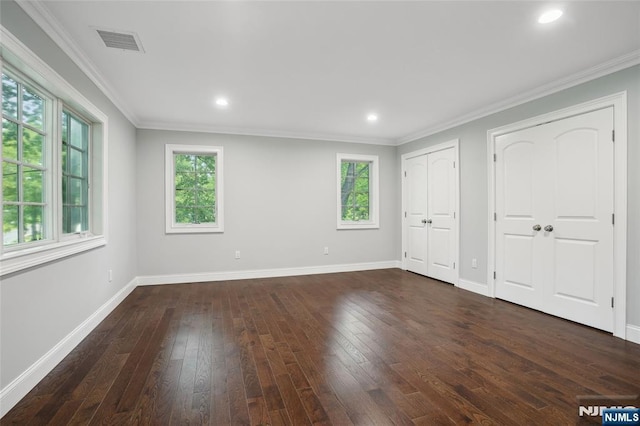 unfurnished bedroom with baseboards, dark wood-style floors, and ornamental molding