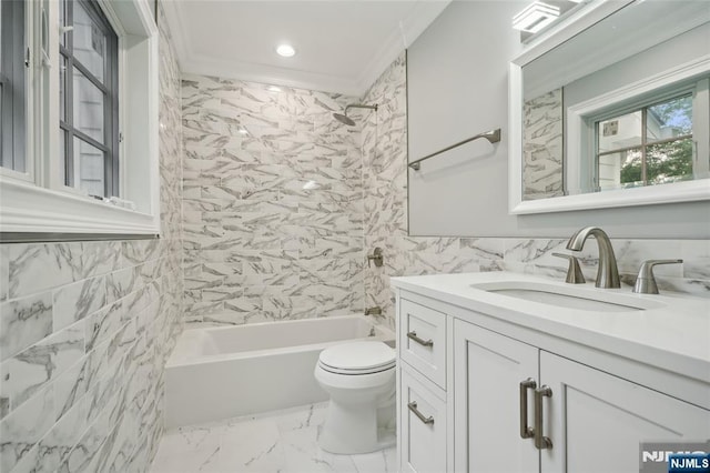 bathroom featuring toilet, marble finish floor, ornamental molding, tile walls, and vanity