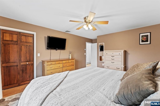 bedroom featuring visible vents, ceiling fan, and light wood finished floors