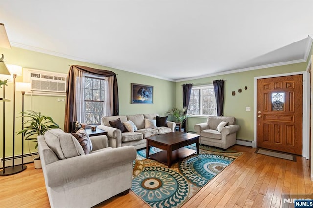 living room with light wood finished floors, ornamental molding, baseboard heating, and a wall mounted air conditioner