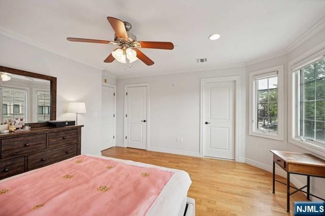 bedroom featuring baseboards, visible vents, ornamental molding, light wood-style floors, and recessed lighting