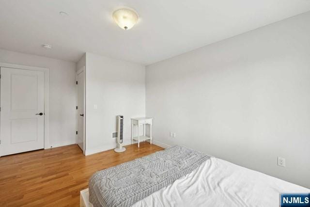 bedroom with wood finished floors