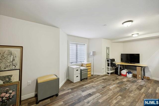 office space with wood finished floors and baseboards