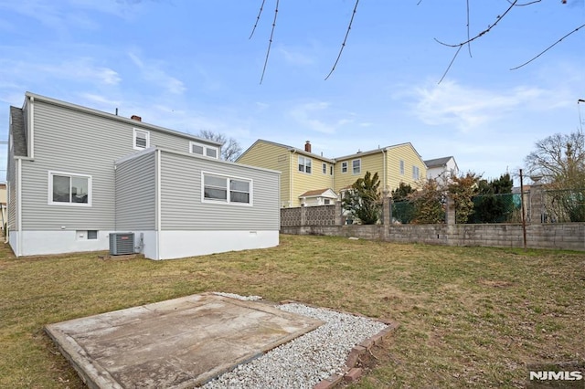 back of house with cooling unit, a patio, a yard, and fence