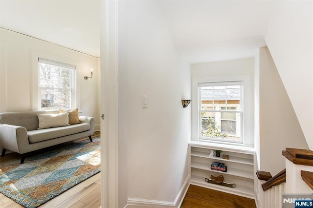 interior space featuring baseboards and wood finished floors