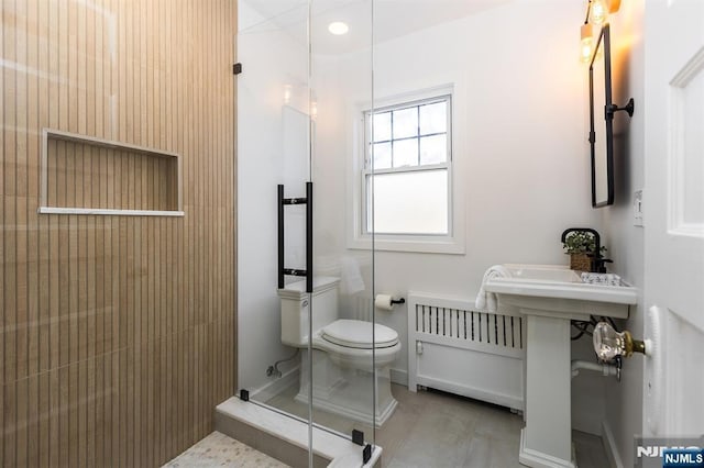 full bath featuring radiator, toilet, and walk in shower