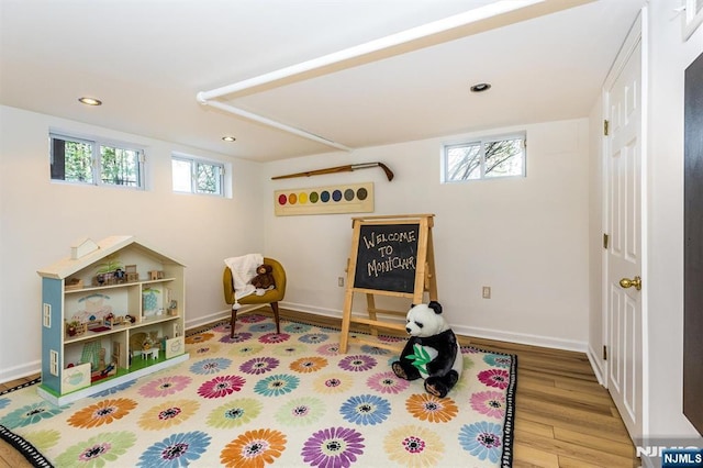 rec room featuring recessed lighting, baseboards, and wood finished floors