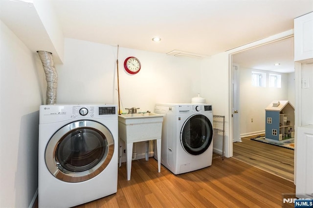 laundry room featuring washer / clothes dryer, wood finished floors, and recessed lighting