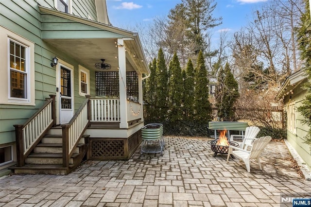 view of patio featuring a fire pit and ceiling fan