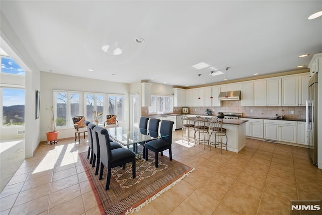 dining room featuring light tile patterned floors and recessed lighting