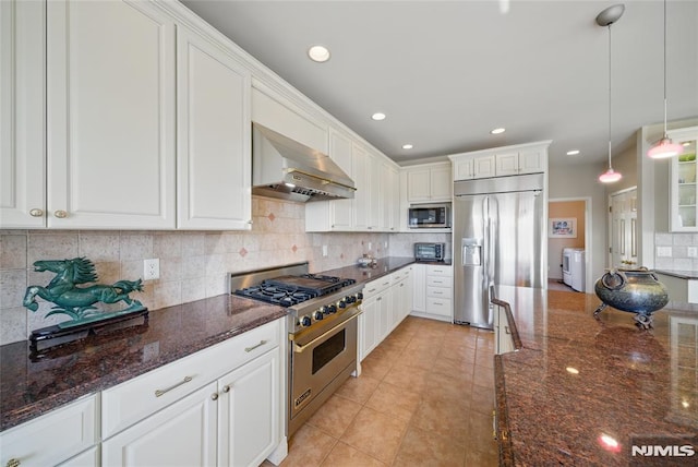 kitchen featuring backsplash, white cabinets, wall chimney exhaust hood, and built in appliances