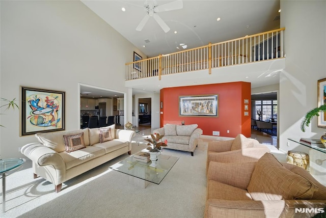 living area with recessed lighting and a ceiling fan