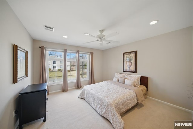 bedroom with recessed lighting, visible vents, light carpet, and baseboards