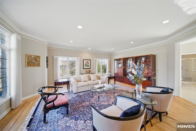 living area with recessed lighting, baseboards, light wood finished floors, and ornamental molding