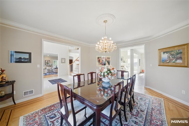 dining space featuring crown molding, stairway, baseboards, and visible vents