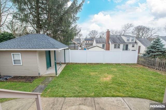 view of yard with a fenced backyard