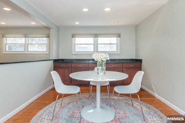 dining area featuring plenty of natural light, baseboards, and wood finished floors