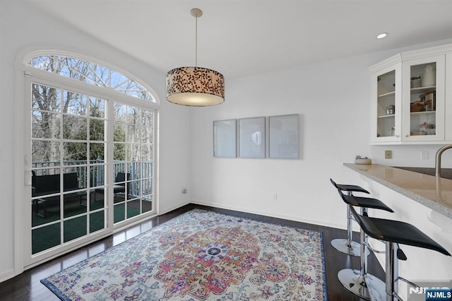 dining room featuring recessed lighting, baseboards, and wood finished floors