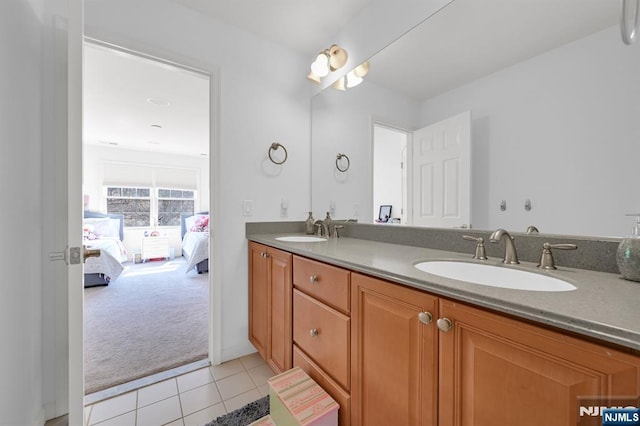 full bath featuring a sink, connected bathroom, double vanity, and tile patterned floors