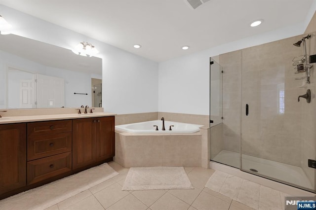 bathroom featuring a sink, a bath, a shower stall, and tile patterned flooring