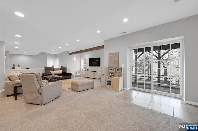 living room with light tile patterned floors, visible vents, baseboards, recessed lighting, and light colored carpet