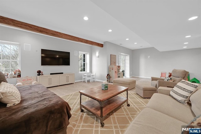 living area featuring beam ceiling, recessed lighting, light colored carpet, and baseboards