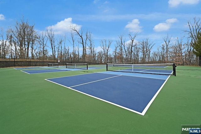 view of sport court featuring fence